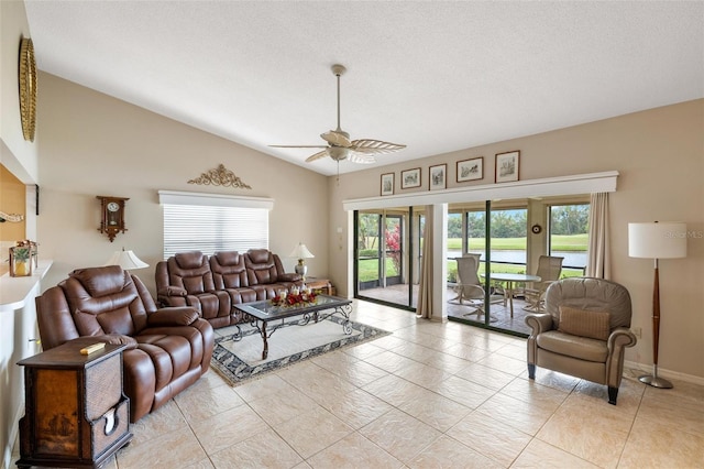 living area featuring ceiling fan, a textured ceiling, baseboards, and vaulted ceiling