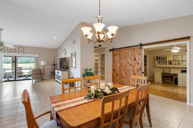 dining space featuring a barn door, lofted ceiling, built in shelves, and light tile patterned flooring