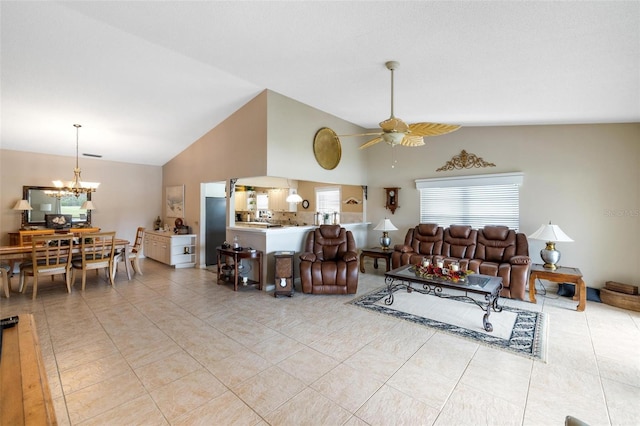 living room with vaulted ceiling, light tile patterned floors, and ceiling fan with notable chandelier