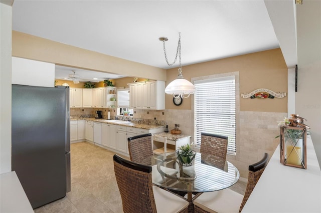 dining space with light tile patterned floors and tile walls