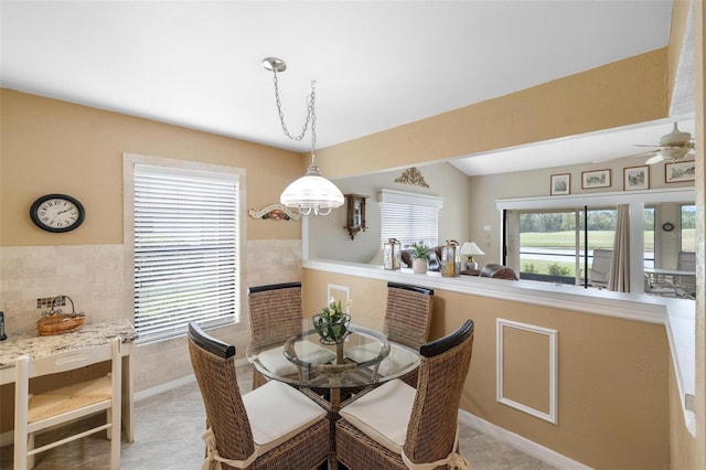 dining room featuring light tile patterned floors and tile walls