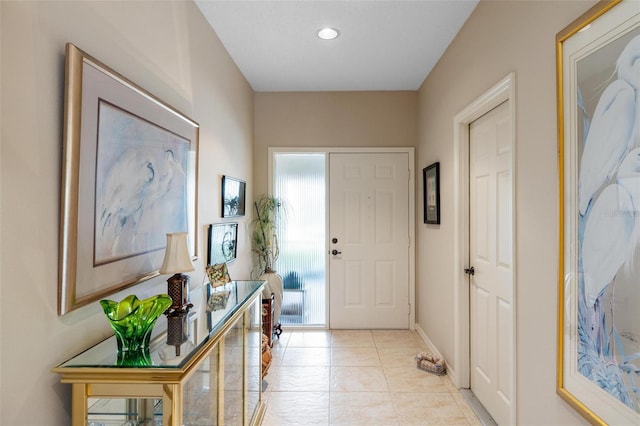 doorway with light tile patterned flooring, recessed lighting, and baseboards