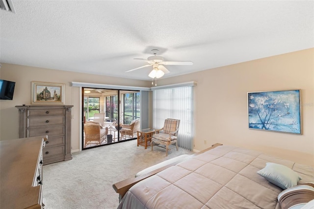 bedroom featuring a ceiling fan, visible vents, access to exterior, a textured ceiling, and carpet flooring