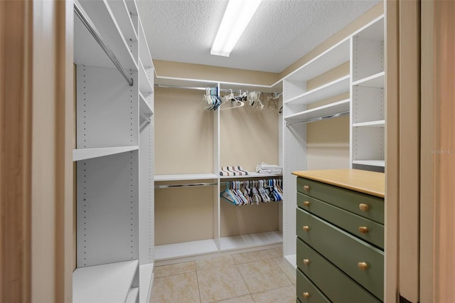 walk in closet featuring light tile patterned flooring