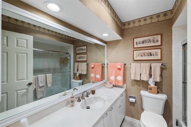 full bath with an enclosed shower, toilet, vanity, and baseboards