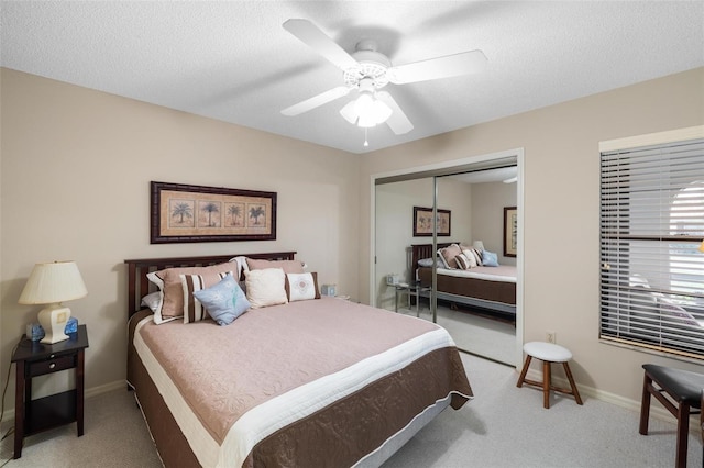 bedroom featuring carpet flooring, baseboards, a closet, and a textured ceiling