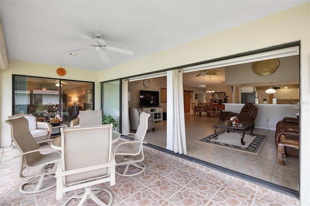 view of patio with outdoor dining area and ceiling fan