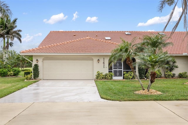 mediterranean / spanish house featuring a front yard, an attached garage, a tile roof, and stucco siding