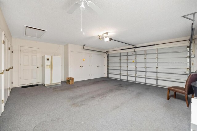 garage with a garage door opener and ceiling fan