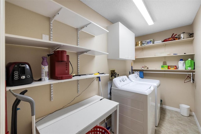 washroom featuring washer and dryer and baseboards