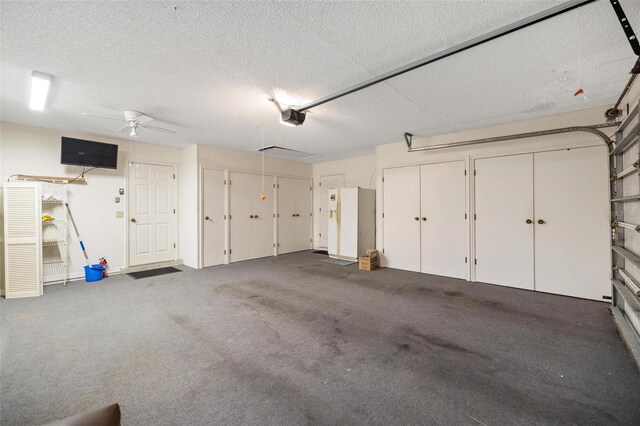 garage with a ceiling fan and a garage door opener