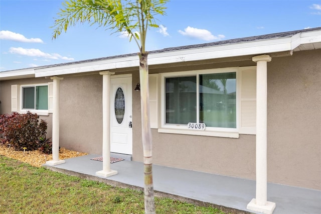 doorway to property with stucco siding