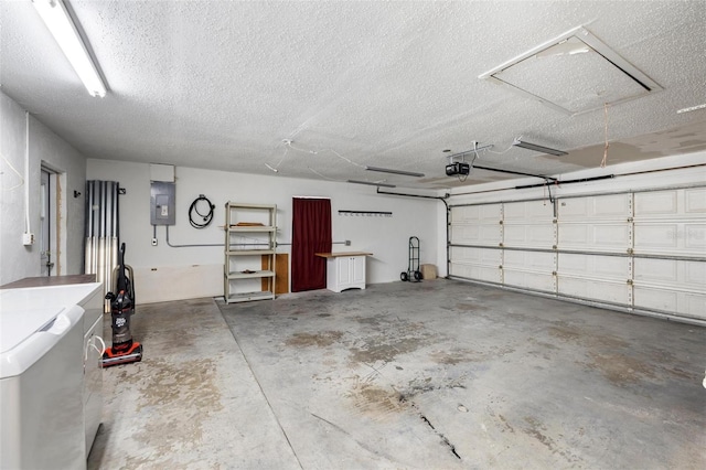 garage with electric panel and a garage door opener