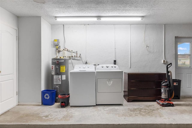 laundry area featuring laundry area, electric water heater, a textured ceiling, and separate washer and dryer