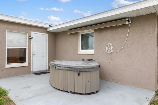 view of patio / terrace with a hot tub