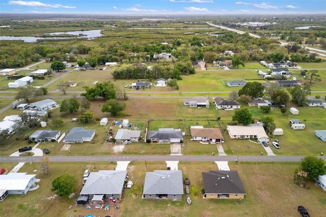 birds eye view of property featuring a water view and a residential view