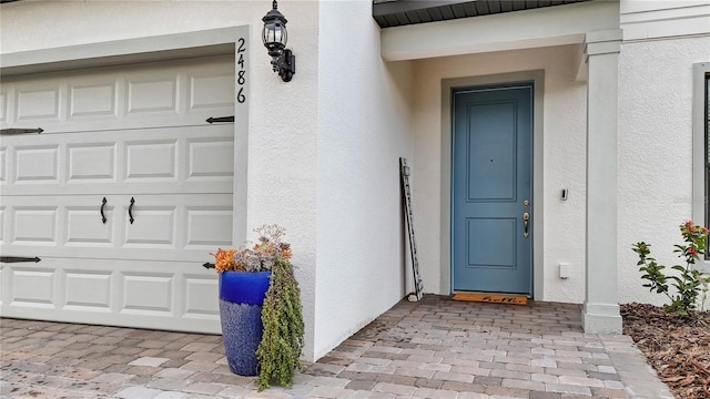 property entrance with stucco siding