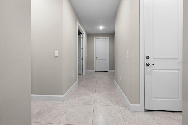 hall featuring baseboards