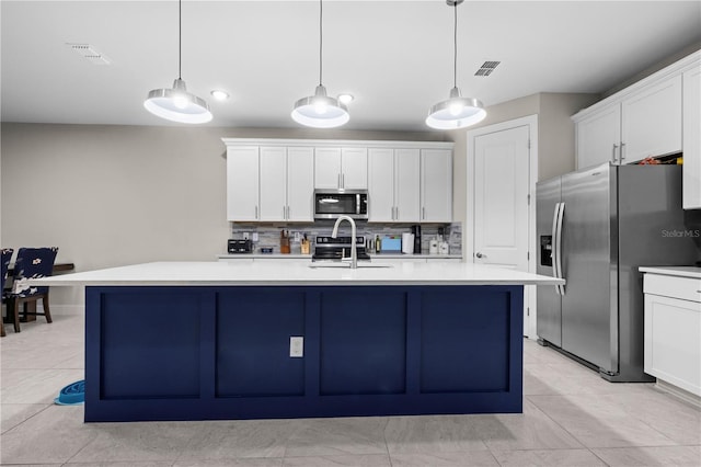 kitchen featuring appliances with stainless steel finishes, light countertops, visible vents, and a sink