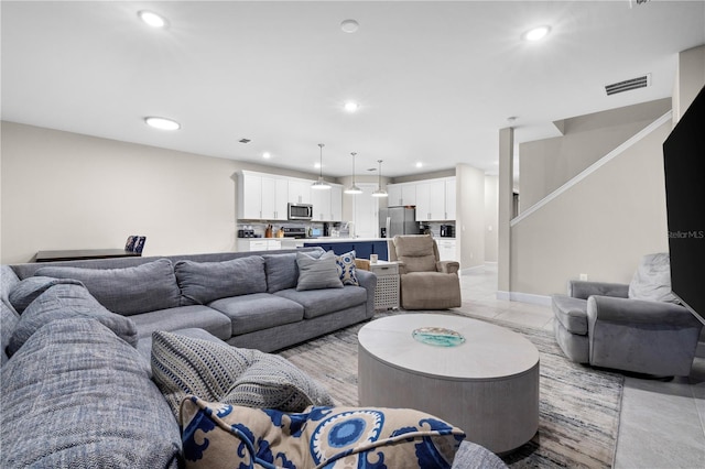 living area with baseboards, stairway, visible vents, and recessed lighting