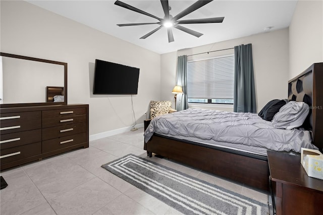 bedroom featuring light tile patterned floors, baseboards, and a ceiling fan