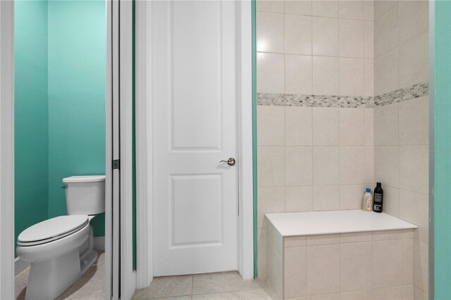 bathroom with tile patterned flooring and toilet