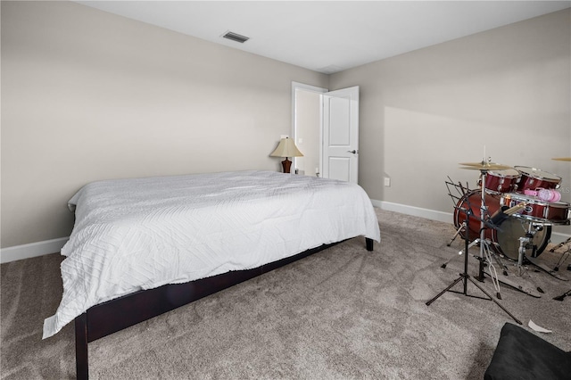 carpeted bedroom with visible vents and baseboards