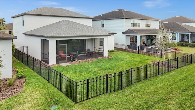 rear view of house with roof with shingles, a patio, a lawn, a sunroom, and a fenced backyard