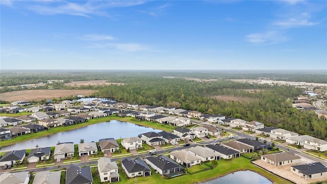 drone / aerial view featuring a residential view and a water view