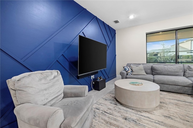 living area with visible vents and recessed lighting