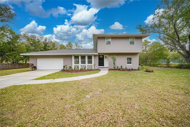 view of front facade with stucco siding, concrete driveway, fence, a garage, and a front lawn