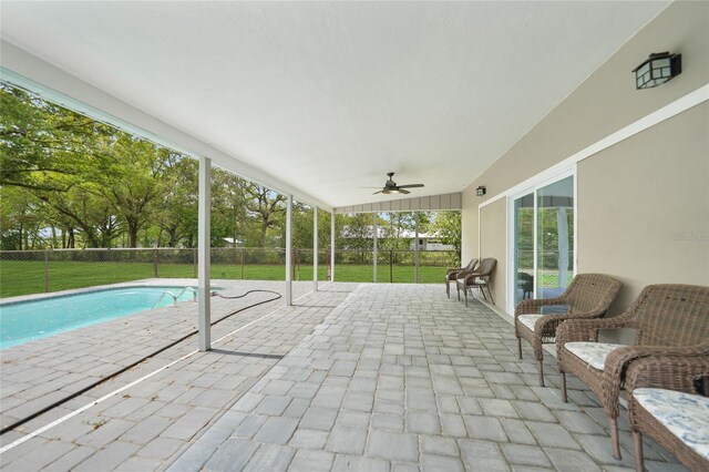 exterior space featuring ceiling fan, fence, and a fenced in pool