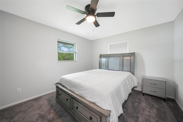 bedroom featuring ceiling fan, dark carpet, and baseboards