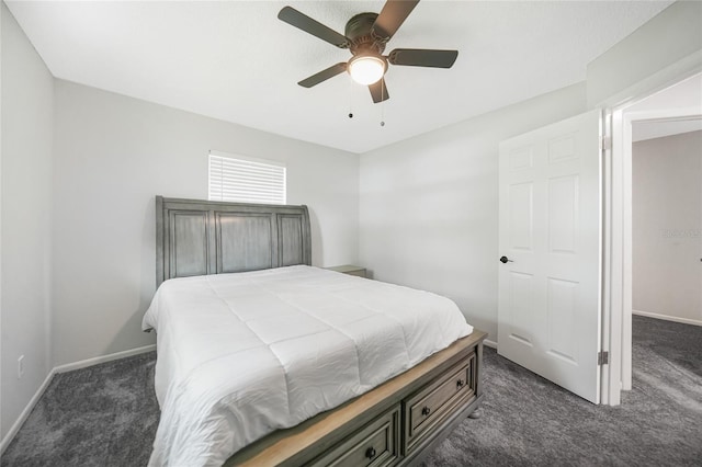 bedroom featuring baseboards, dark carpet, and a ceiling fan