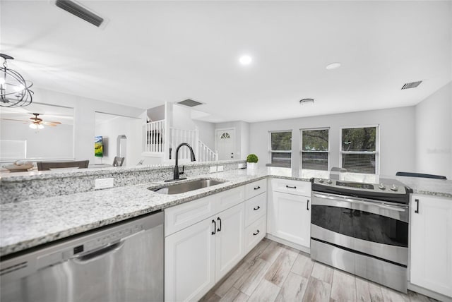 kitchen with white cabinets, visible vents, stainless steel appliances, and a sink