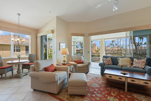 sunroom featuring lofted ceiling and ceiling fan with notable chandelier