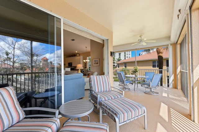 sunroom / solarium featuring a ceiling fan