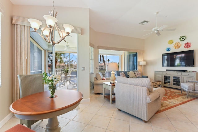 living room with visible vents, baseboards, light tile patterned flooring, and ceiling fan with notable chandelier