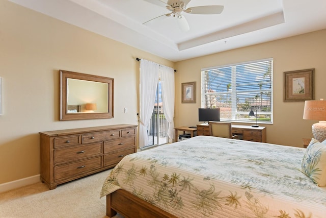 bedroom featuring baseboards, a tray ceiling, ceiling fan, light carpet, and access to outside