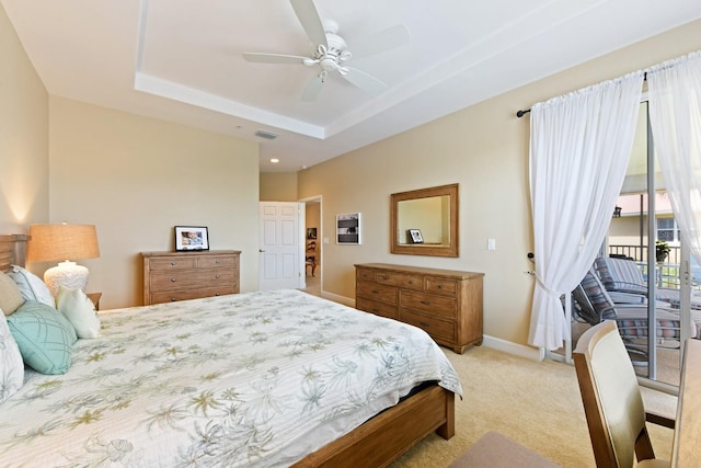 bedroom featuring access to exterior, visible vents, baseboards, light colored carpet, and a tray ceiling