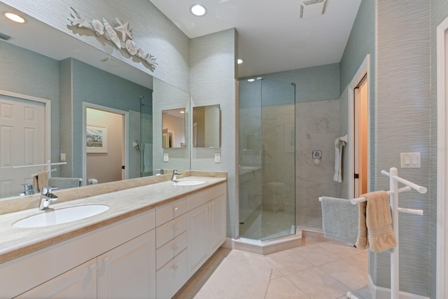 bathroom featuring a shower stall, visible vents, tile patterned floors, and a sink