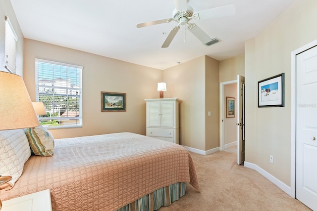 bedroom featuring visible vents, light carpet, baseboards, and ceiling fan