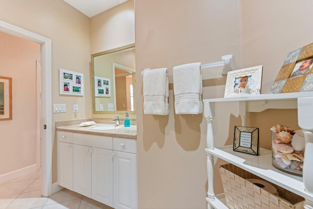 bathroom with tile patterned floors, baseboards, and vanity