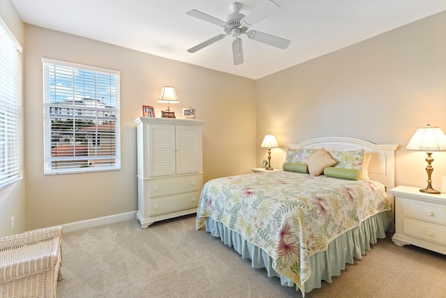 bedroom with ceiling fan, baseboards, and carpet floors