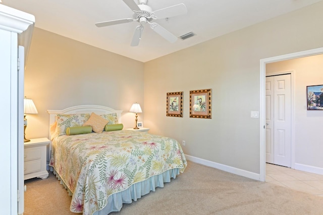 bedroom featuring tile patterned flooring, visible vents, baseboards, carpet floors, and a ceiling fan