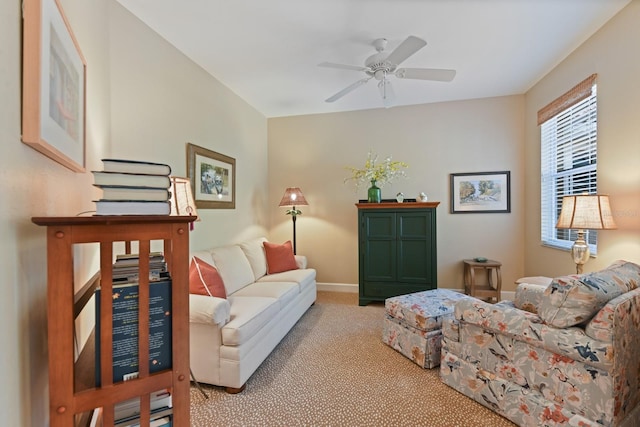 living room with baseboards, carpet floors, and ceiling fan