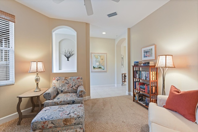 sitting room featuring carpet, baseboards, visible vents, and ceiling fan