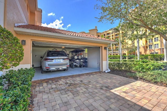 garage with decorative driveway