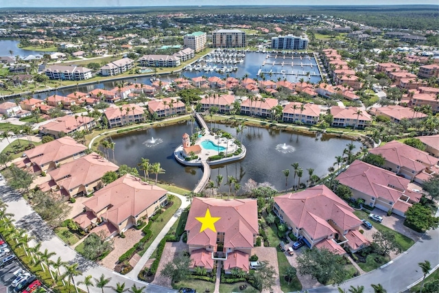 drone / aerial view with a residential view and a water view