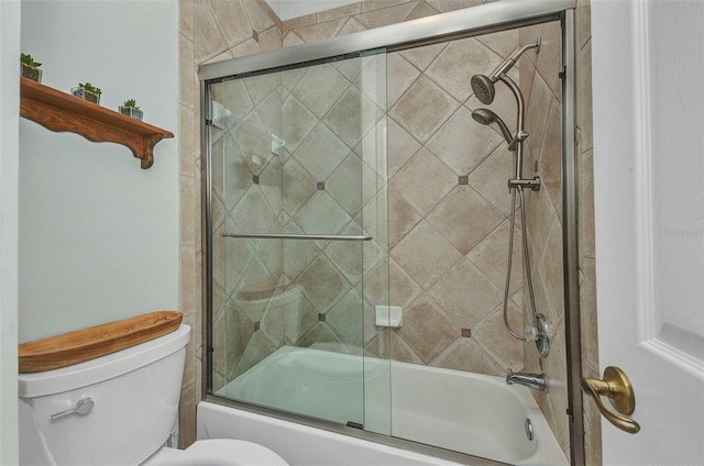 bathroom featuring toilet and combined bath / shower with glass door